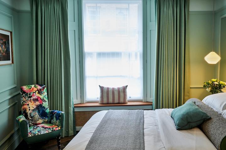 A forest-hued bedroom at Notting Hill hotel, The Lost Poet