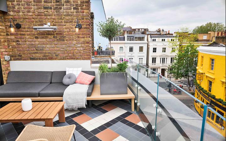 Colourful Notting Hill houses peer over the terrace at The Lost Poet